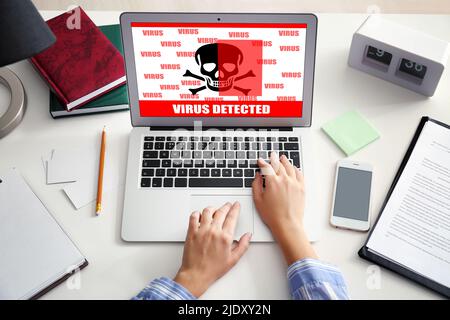 Woman using laptop in office. Antivirus concept Stock Photo