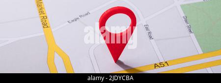 High Angle View Of Navigation Map With Red Pin Pointer Stock Photo