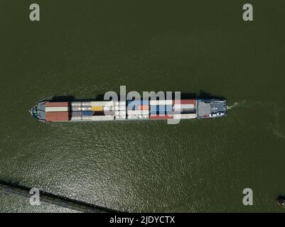 Amsterdam, 12th of June 2022, The Netherlands. Heavy transport container bulk carrier freighter overhead top down view on sea lake open water isolated Stock Photo