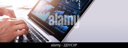Close-up Of A Businessman's Hand Analyzing Graph On Laptop Stock Photo