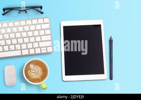 Top view Minmal workspace with glasses, keyboard and coffee cup copy space on blue background. flat lay style and business concept. Stock Photo