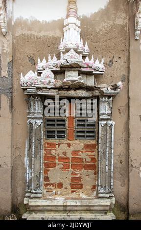 Partially walled window with decoration in an old Buddhist temple Stock Photo