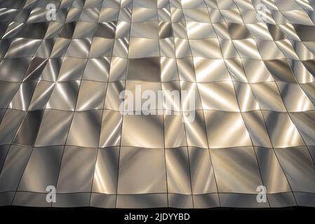 Sculptural, contemporary design, building clad in 3D formed, metal panels. Perforated panels conceal windows. Modern architecture. Stock Photo