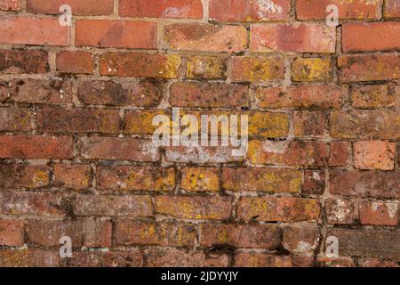 Wall made of old discoloured bricks Stock Photo