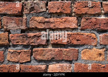 Wall made of old discoloured bricks Stock Photo
