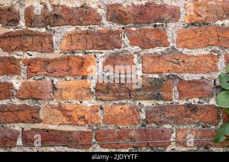 Wall made of old discoloured bricks Stock Photo