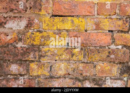 Wall made of old discoloured bricks Stock Photo
