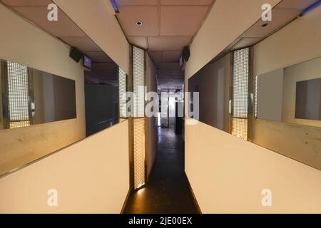 Corridors of a nightclub with frameless mirrors and neon lights Stock Photo