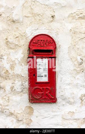 GR Post box in a white rough rendered wall Stock Photo