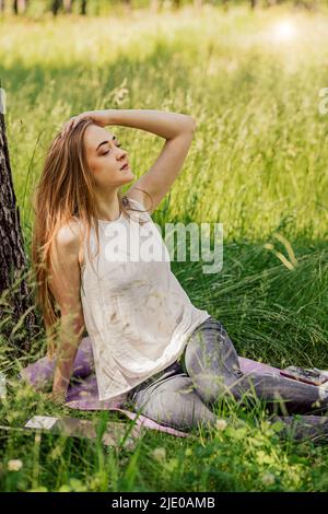 girl is sitting on resting from work. freelance. selfeducation. the concept of remote learning and outdoor work Stock Photo