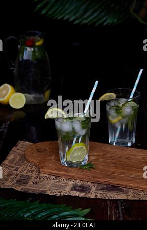 Summer infused water with lemon, lime and mint. Refreshing, diet, detox natural fortified water. Hard seltzer with nootropics. Healthy natural cocktails. Summertime beverages. Stock Photo