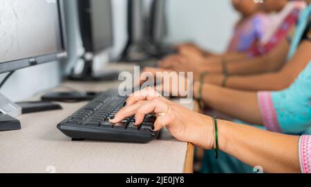 close up shot of group of women hads busy learning or working on computer at training center by typing - concept of empowerment, learning and Stock Photo