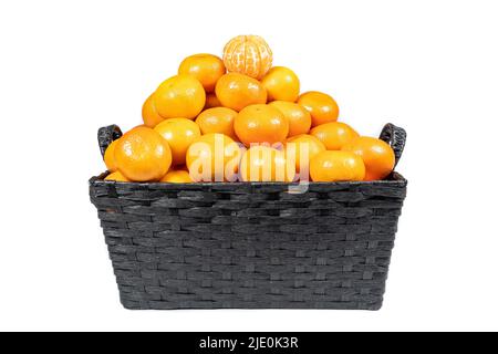 Basket of stacked tangerines on isolated white background. Stock Photo