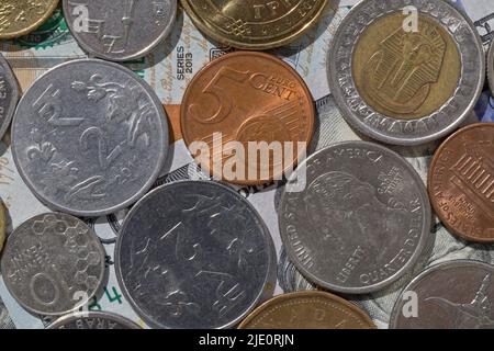 currency exchange: different countries coins lying on banknotes Stock Photo