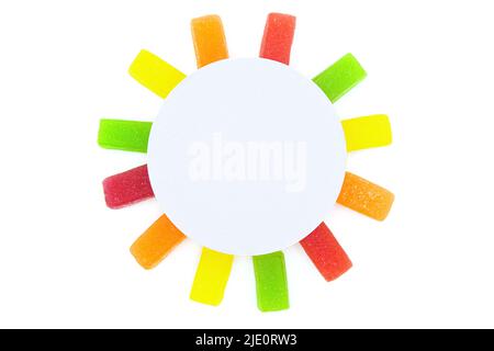 Jelly candies arranged into a sun shape isolated on white. Vivid summer background. Stock Photo