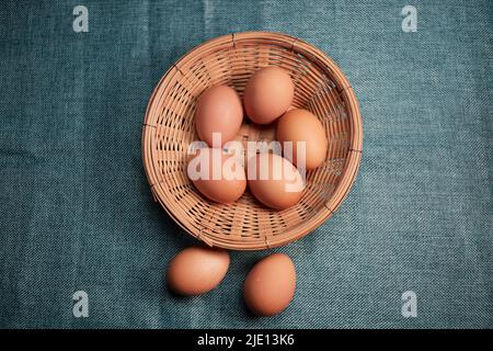 Chicken eggs in the wicker basket Stock Photo