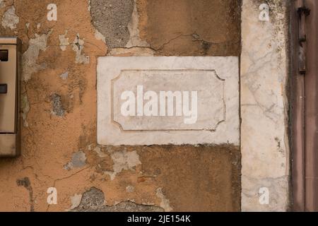 Blank marble plate on a yellow concrete old wall Stock Photo