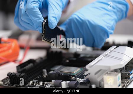 Microprocessor Socket. Shop Technician connects a CPU microprocessor to motherboard socket Stock ...