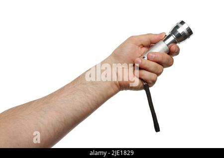 Close up of hand holding an aluminum electric flashlight and pressing the power button. Isolated on white background with clipping path Stock Photo