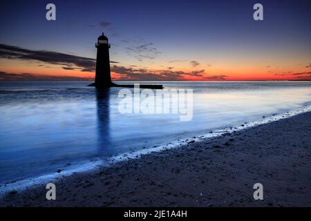Dawn over Talacre lighthouse on the North Wales coast Stock Photo