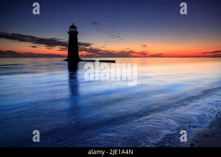 Dawn over Talacre lighthouse on the North Wales coast Stock Photo