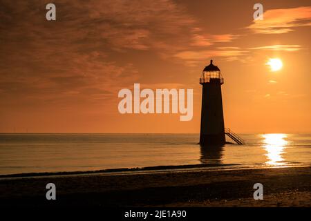 Sunrise over Talacre lighthouse on the North Wales coast Stock Photo