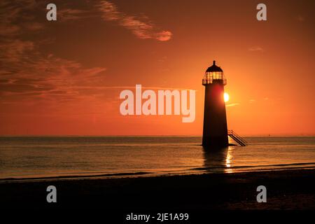 Sunrise over Talacre lighthouse on the North Wales coast Stock Photo