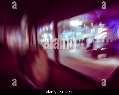 Public transportation and tourism concept blurred multicolored.  Out of focus bokeh photo of city bus speeding up. Stock Photo