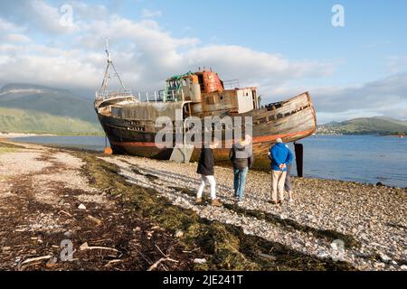 Visitors at Old boat of Caol aka Corpach Shipwreck at Fort William, Highland, UK Stock Photo