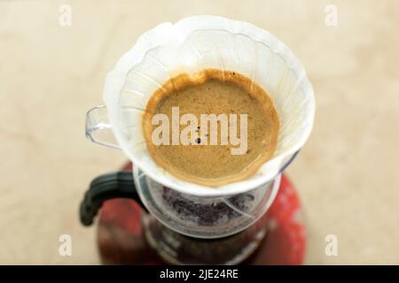 Top view of alternative method of brewing v60 coffee in a glass drip decanter. Stock Photo