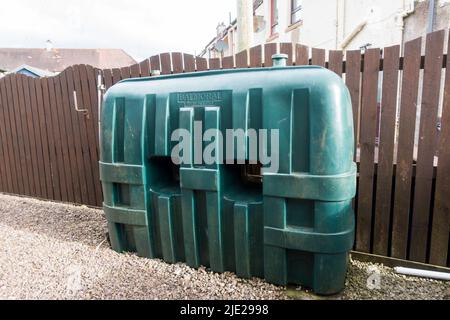 Single skin storage tanks to store Kerosene heating oil placed in the pebble layered garden floor Stock Photo