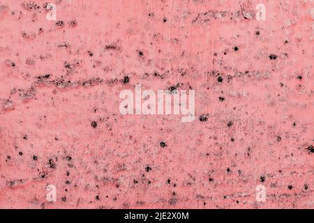 Black spots of fungal bacteria and mold on a red wall in a house or apartment. The concept of excessive humidity, improper air exchange and condensation. Poor ventilation. Soft focus. Stock Photo