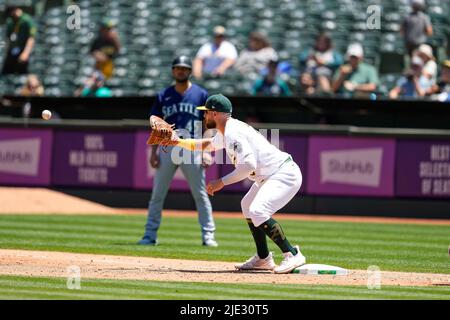 Oakland Athletics Infielder Seth Brown (15) catches the ball for an out at first base during an MLB game between Seattle Mariners and Oakland Athletic Stock Photo