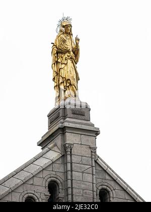 Sainte-Anne-de-Beaupre, Canada - May 23 2022: Sainte-Anne-de-Beaupre statue on the top of Sanctuaire de Sainte-Anne-de-Beaupré Stock Photo