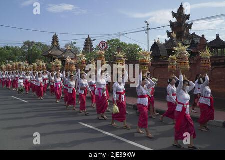 DENPASAR, JUNE 19 2022: the mepeed activity of a traditional village in Denpasar Bali was attended by women wearing traditional Balinese clothes. They Stock Photo