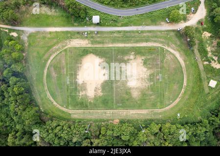 Aerial view of empty green football field with running track outdoor Empty soccer field view from top Stock Photo