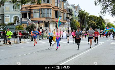 Scenes from the 2022 Bay to Breakers 12k foot race in San Francisco, California; participants, racers, walkers wearing costumes on Fell Street. Stock Photo
