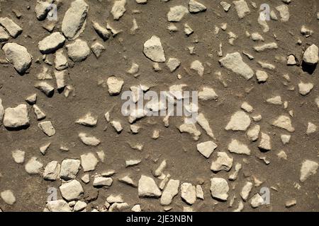 Rocks on road. Fine stone texture. Surface of rural road. Stock Photo
