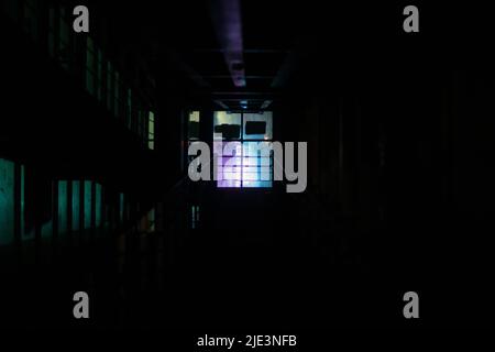 Window light in dark. Neon glow in night building. Pedestrian crossing without light. Stock Photo