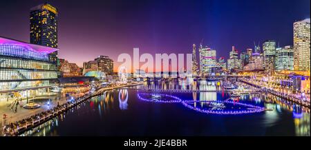 Bright sunset panorama of Darling harbour Cockle bay in Sydney city CBD at Vivid Sydney light festival show. Stock Photo