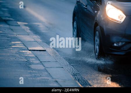 Fragment of car on wet road Stock Photo