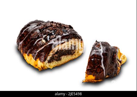 Closeup view pieces of homemade croissant pouring and filling with chocolate isolated on white background with clipping path. Stock Photo