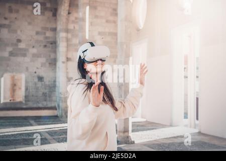 Woman wearing vr headset in european street, virtual travel concept Stock Photo