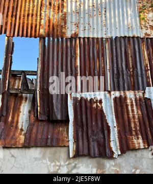 Old rusted galvanized wall conbined with the concrete wall, multi-colored of old zinc, brown, dark brown Stock Photo