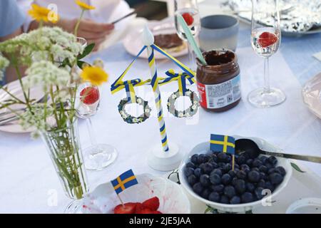 The celebration of Swedish Midsummer Eve on Friday. Here during a breakfast. Stock Photo