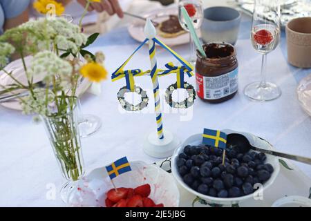 The celebration of Swedish Midsummer Eve on Friday. Here during a breakfast. Stock Photo