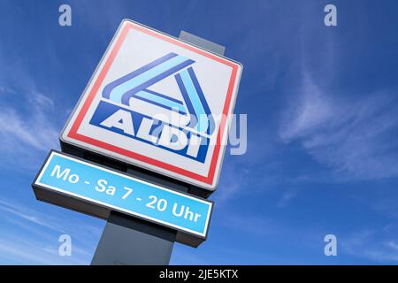 Aldi sign (north division) against blue sky Stock Photo