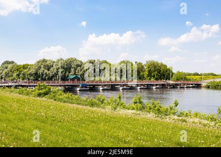 view of Bobrenevskiy pedestrian movable pontoon bridge on Moskva River in Kolomna city on sunny summer day Stock Photo