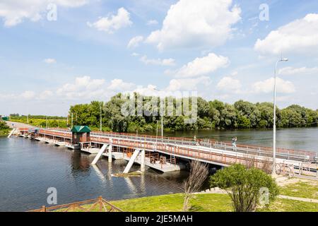 Bobrenevsky pedestrian movable pontoon bridge on Moskva River in Kolomna city on sunny summer day Stock Photo