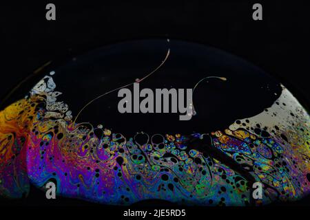 Beautiful psychedelic abstractions on the surface soap bubbles. Stock Photo